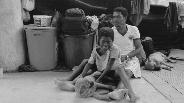 Datu Lando Anlagan, a Mamanwa leader from Agusan del Sur, spends time with his son and their pets while they were in an evacuation center in Butuan City when they were forced to evacuate from their home due to military operations. (Photo by Chantal Eco / Bulatlat.com)