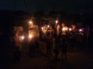 Urban poor holding a light off protest in San Roque, North Triangle, Quezon City. (FILEPhoto by J. Ellao / Bulatlat.com)