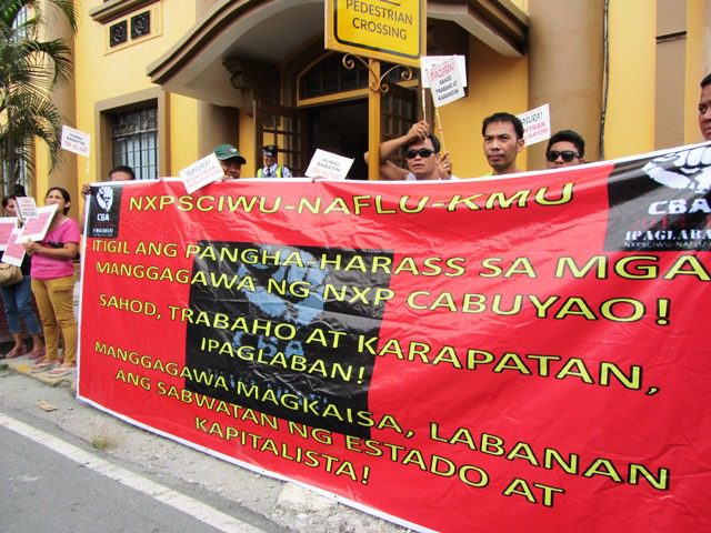 NXP workers picket in front of DOLE as their union negotiators meet with representatives of DOLE and NXP.(Photo by M. Salamat)