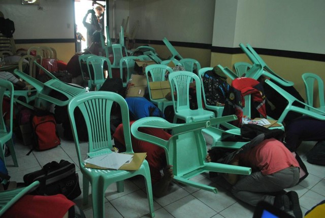 Teacher-trainees "take cover" under chairs during a trainors' training in NCR. (Photo from CDRC Facebook account)