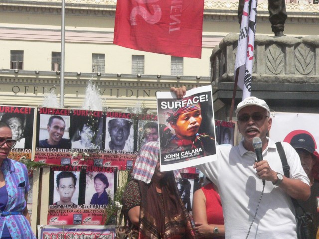 'HE WILL NOT BE THE LAST.' Acclaimed writer and activist Bonifacio Ilagan holds a picture of missing Manobo leader John Calaba. (Photo by D.Ayroso/Bulatlat.com)