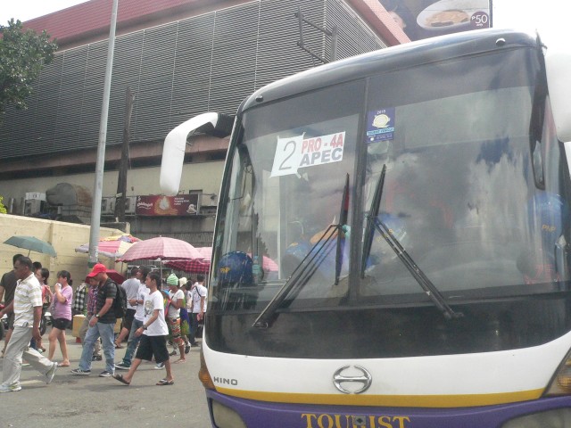 One of the buses outside the Baclaran church compound, with police men resting inside (Photo by D. Ayroso/Bulatlat.com)