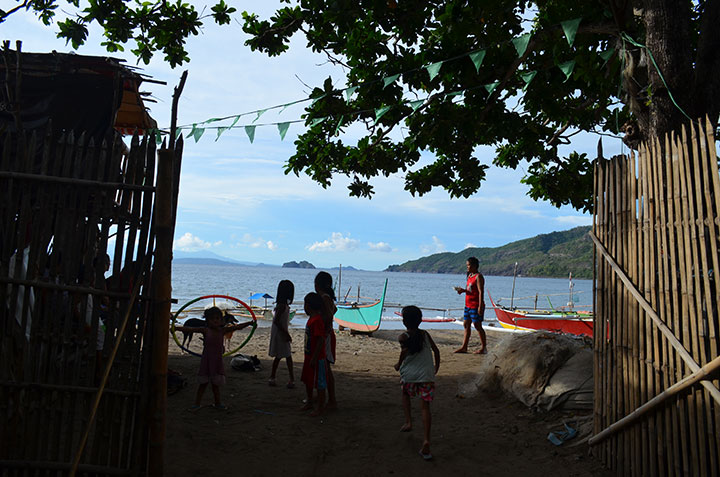 Children playing along the shores of Patungan Cove is a common sight in the coastal barangay Sta Mercedes in Maragondon, Cavite. The cove faces the famous Corregidor and Carabao Islands of Bataan province in the south. (Photo by Jen Guste / Bulatlat)